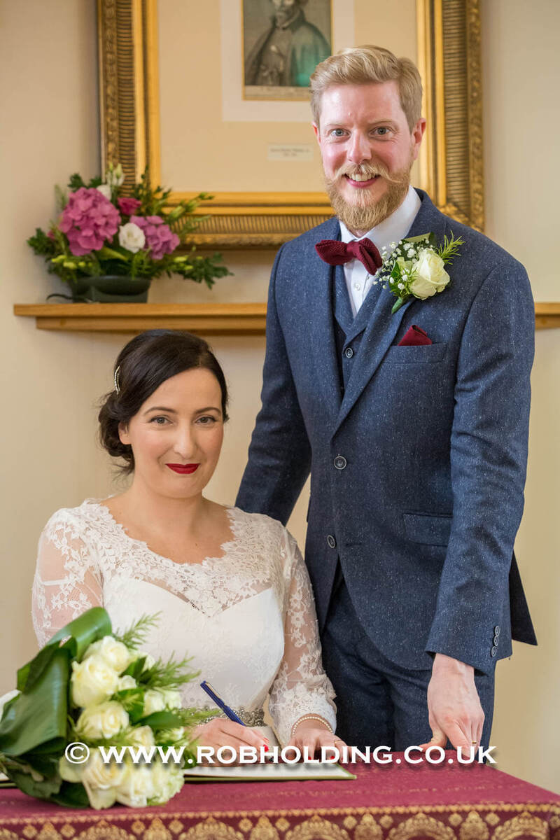 Close-up detail of the bride and groom’s outfits together