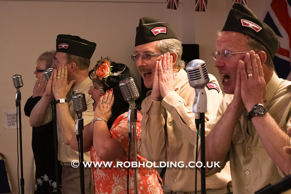 Performers in vintage military-style costumes singing at the reception