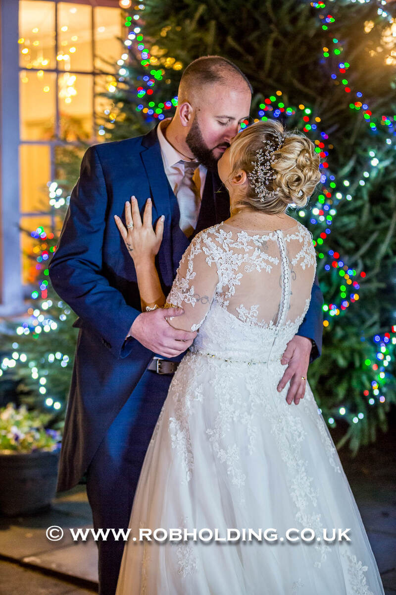 Bride and groom dancing closely indoors