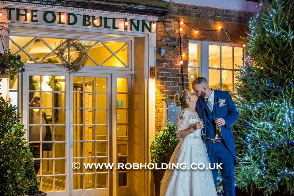 Bride and groom outside The Old Bull Inn at night