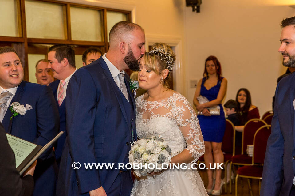 Bride and groom standing with guests at the reception