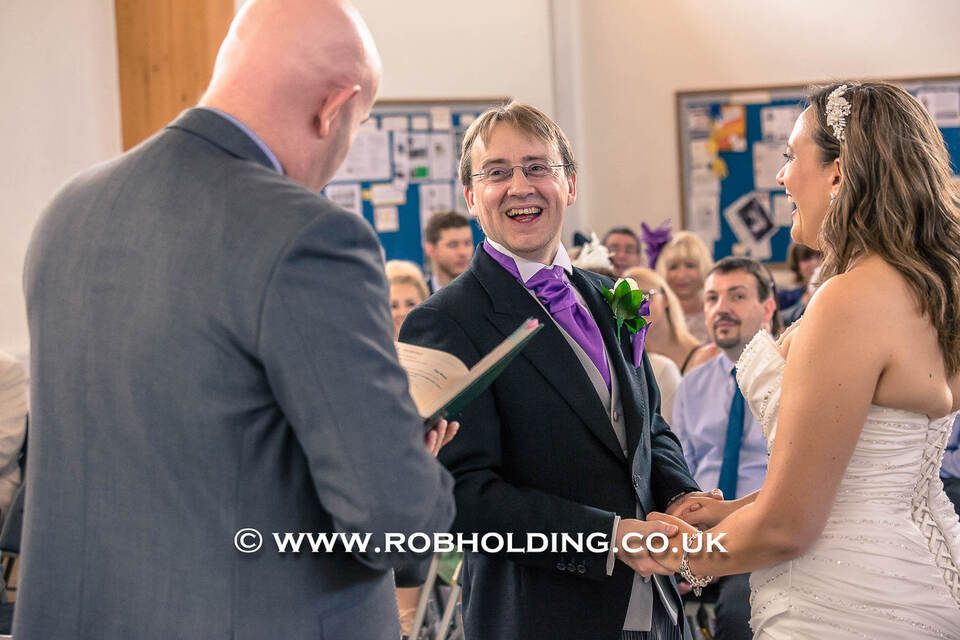 Officiant reading during the ceremony between the bride and groom