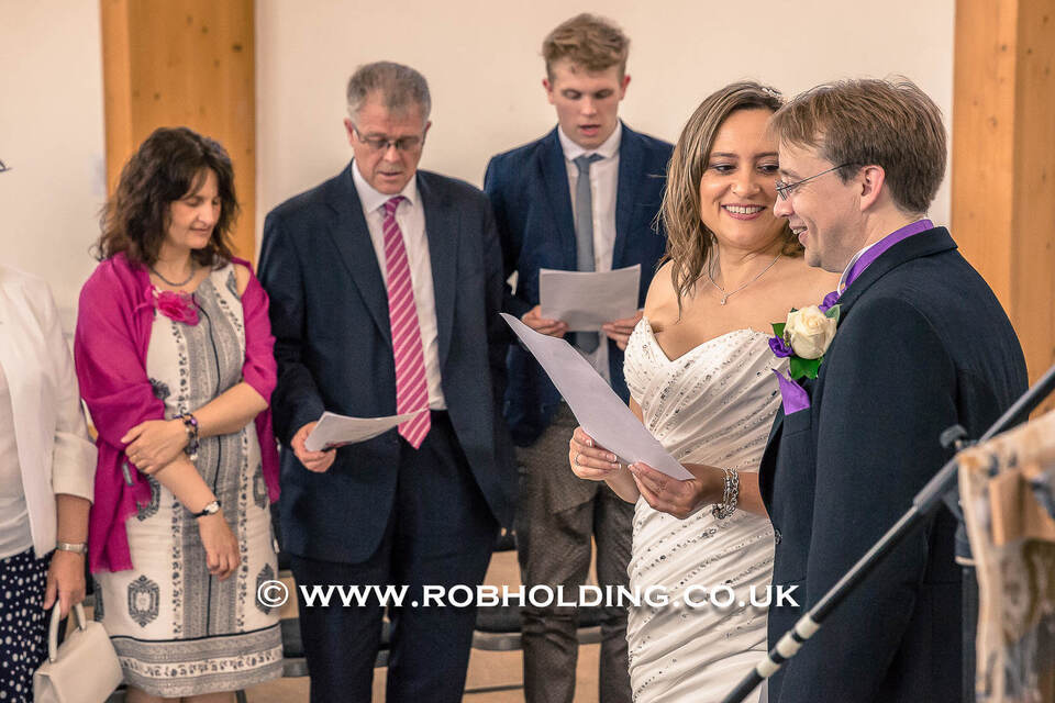 Bride and groom reading vows during the ceremony