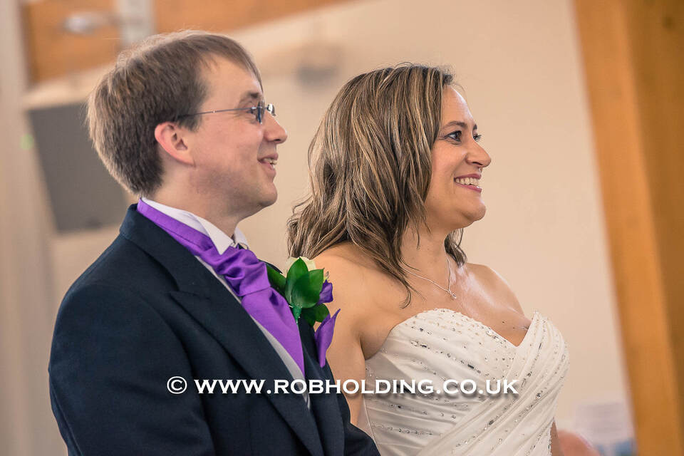 Groom and bride smiling together at their wedding