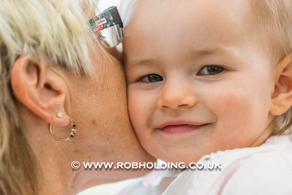 Close-up of a woman and a young child smiling cheek to cheek