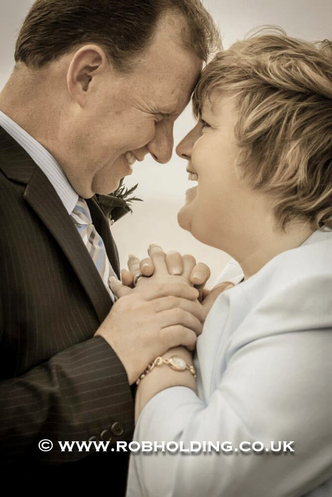 Older couple sharing a tender forehead-touching moment