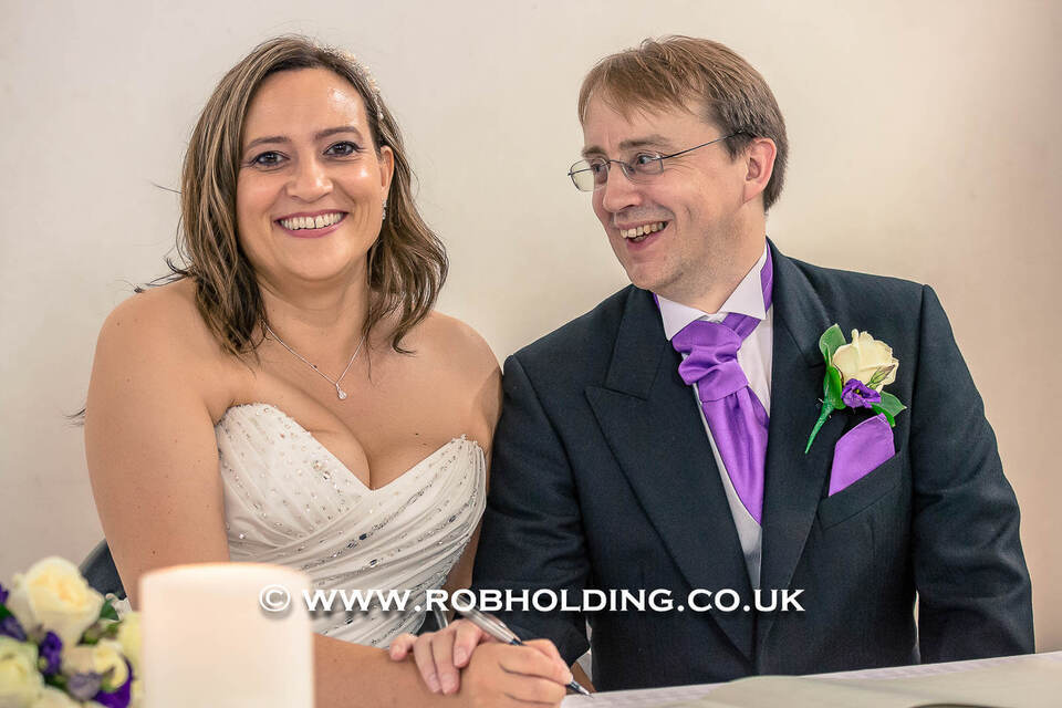 Bride and groom smiling together indoors