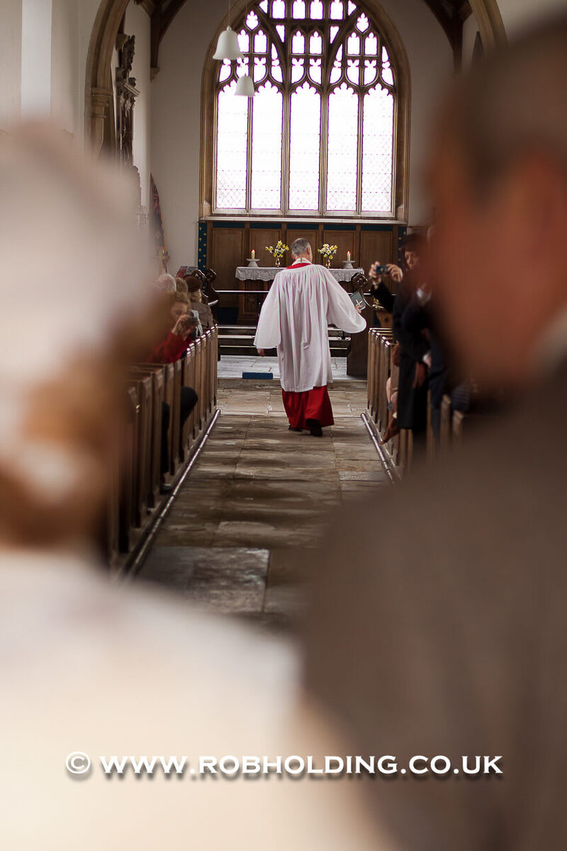 View down the church aisle during the ceremony
