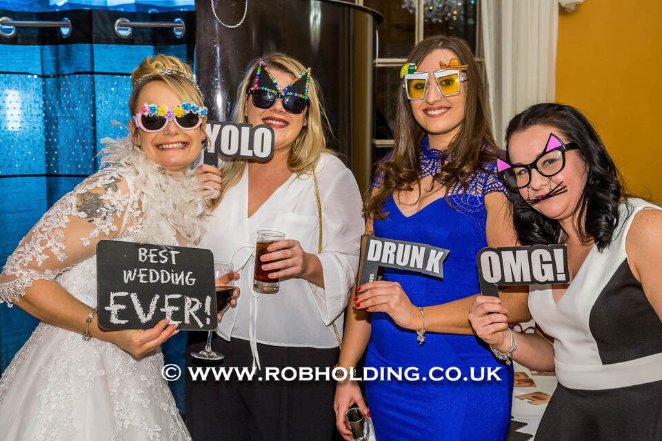 Guests posing with fun photo booth props